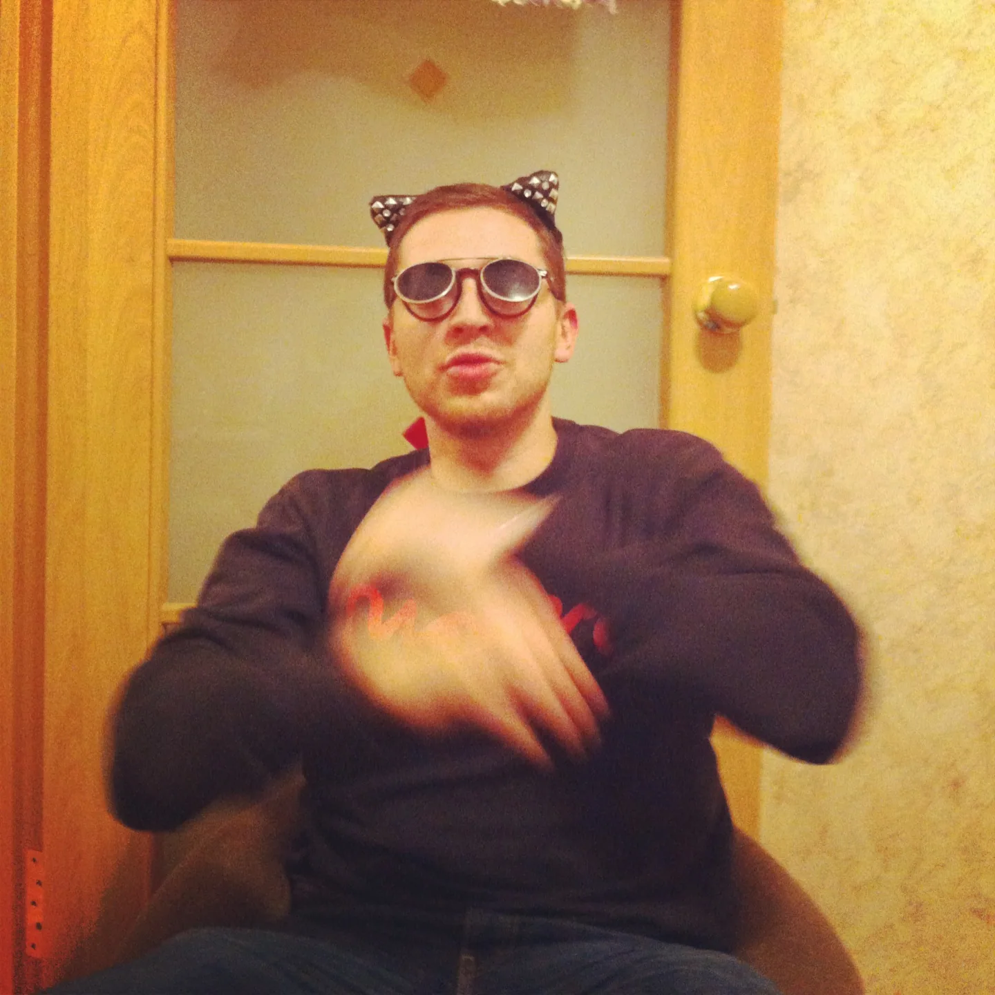 Oxxxymiron in sunglasses and a cat-ear headband, mid-verse